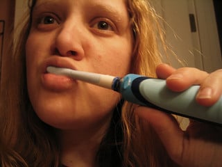 woman brushing teeth